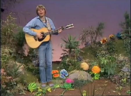 John-Denver-signs-on-the-Muppet-Show-surrounded-by-plants